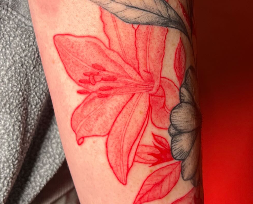 Person with a red flower tattoo on their arm, responding to a message about trust and appreciation.